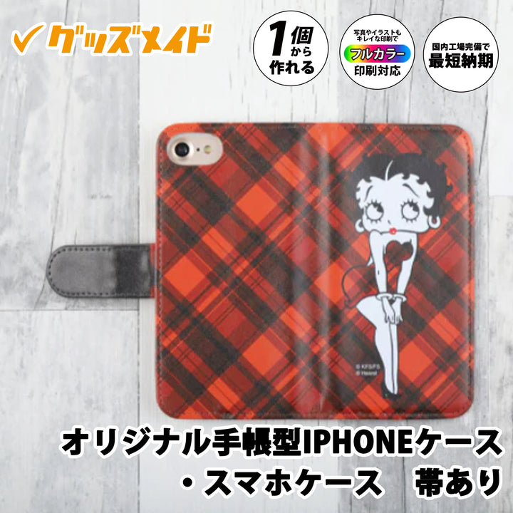オリジナル手帳型iPhoneケース（帯あり）。フラップ付きの手帳型スマホケースで、フルカラー印刷に対応。1個からオリジナル制作可能。赤系チェック柄とキャラクターデザインを施したサンプル例。
